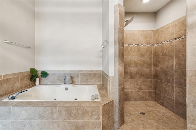 bathroom with tiled shower and a garden tub