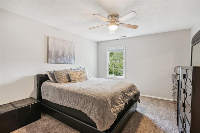 bedroom featuring carpet floors, baseboards, ceiling fan, and a textured ceiling