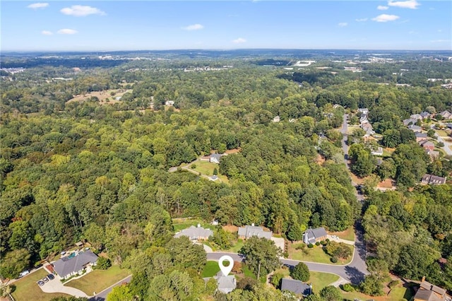 aerial view of property's location with a heavily wooded area