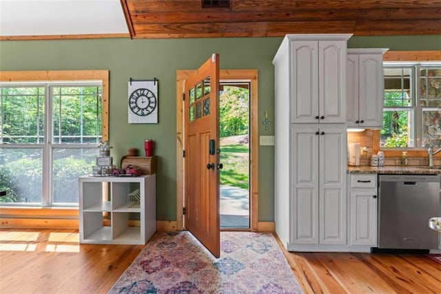 210 Lake Pines Rd, Jackson, GA 30233 - kitchen featuring dishwasher, light wood-style flooring, white cabinets, and light stone countertops