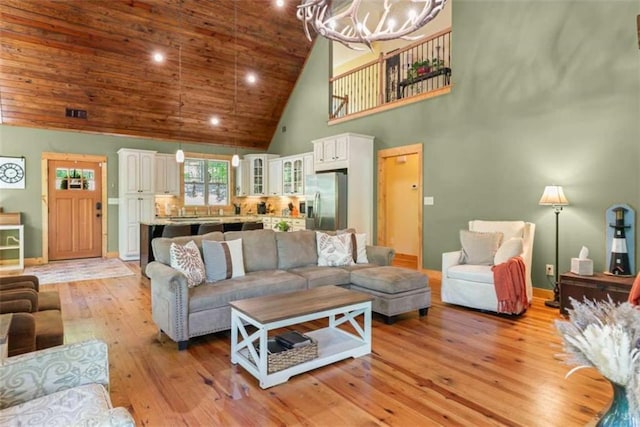 210 Lake Pines Rd, Jackson, GA 30233 - living room with high vaulted ceiling, a chandelier, light wood-style flooring, baseboards, and wooden ceiling