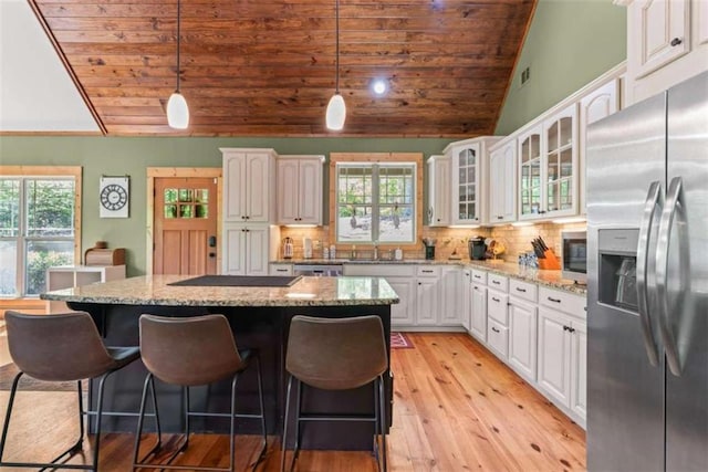 210 Lake Pines Rd, Jackson, GA 30233 - kitchen featuring appliances with stainless steel finishes, wood ceiling, lofted ceiling, light wood-type flooring, and white cabinetry