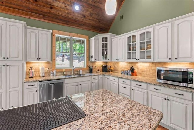 210 Lake Pines Rd, Jackson, GA 30233 - kitchen with appliances with stainless steel finishes, a sink, white cabinetry, glass insert cabinets, and tasteful backsplash