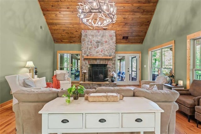 210 Lake Pines Rd, Jackson, GA 30233 - living room with wood ceiling, light wood-style floors, high vaulted ceiling, healthy amount of natural light, and a chandelier