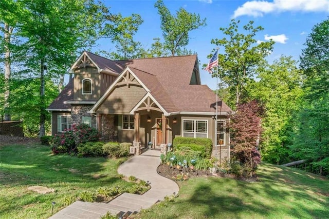 210 Lake Pines Rd, Jackson, GA 30233 - craftsman house featuring stone siding, a front lawn, and covered porch
