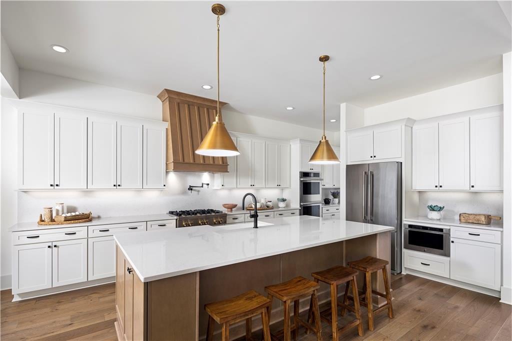 kitchen with appliances with stainless steel finishes, dark wood finished floors, white cabinets, and recessed lighting