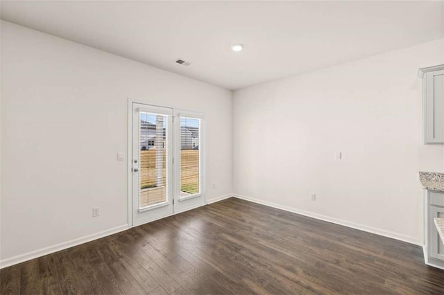 unfurnished room featuring dark hardwood / wood-style flooring