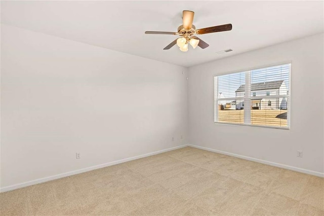 unfurnished room featuring light colored carpet and ceiling fan