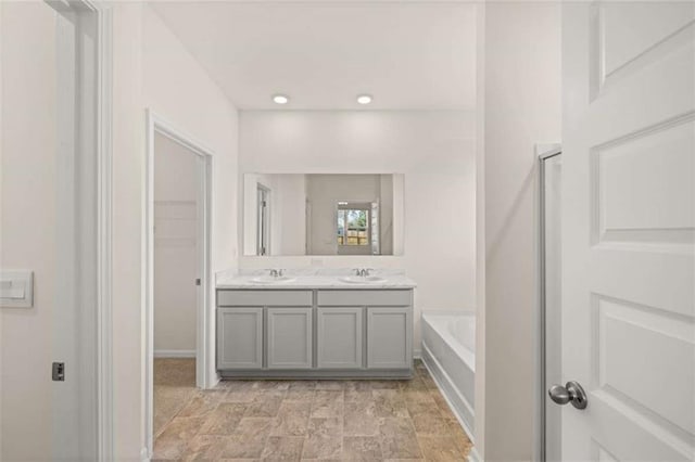 bathroom with vanity and a bathing tub