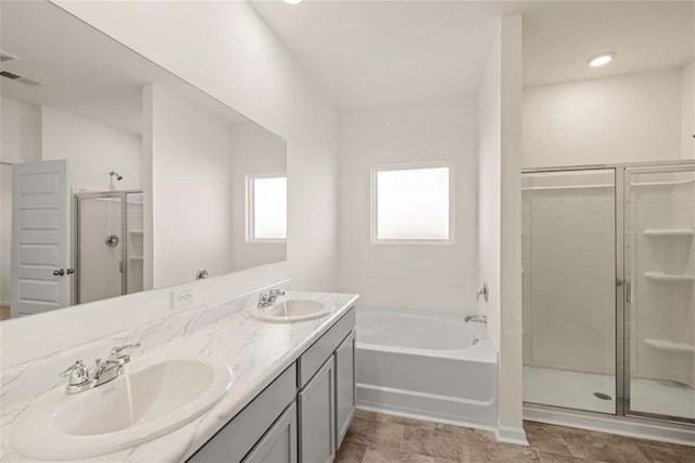 bathroom featuring vanity and shower with separate bathtub