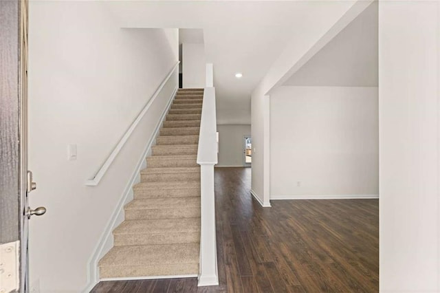 staircase featuring wood-type flooring