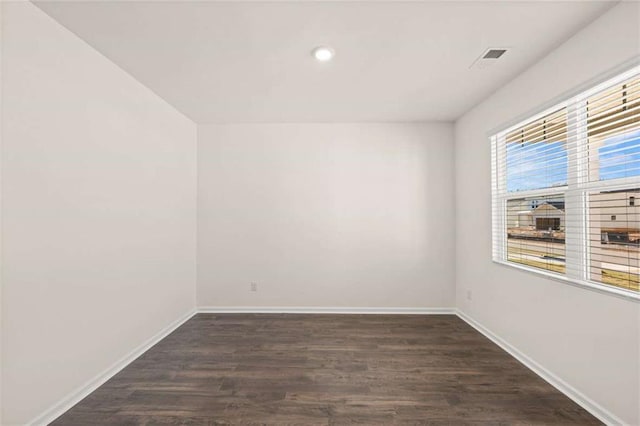 unfurnished room featuring dark wood-type flooring