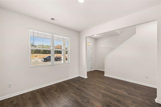 spare room featuring dark hardwood / wood-style flooring