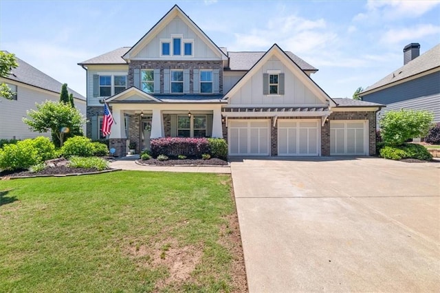 337 Spotted Ridge Cir, Woodstock, GA 30188 - craftsman house with board and batten siding, a front yard, driveway, covered porch, and an attached garage