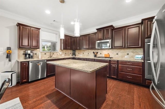 337 Spotted Ridge Cir, Woodstock, GA 30188 - kitchen with appliances with stainless steel finishes, dark brown cabinetry, ornamental molding, hanging light fixtures, and backsplash
