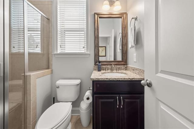 337 Spotted Ridge Cir, Woodstock, GA 30188 - bathroom featuring a stall shower, vanity, toilet, and baseboards
