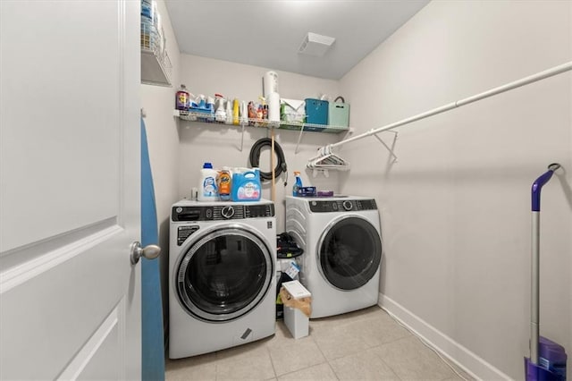 337 Spotted Ridge Cir, Woodstock, GA 30188 - laundry room featuring washing machine and dryer, light tile patterned floors, and baseboards