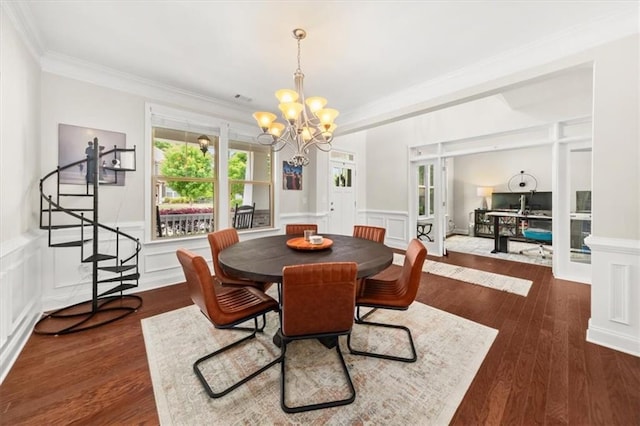 337 Spotted Ridge Cir, Woodstock, GA 30188 - dining area with a chandelier, crown molding, a decorative wall, wainscoting, and wood finished floors