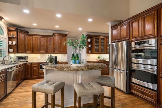 kitchen with open shelves, appliances with stainless steel finishes, a sink, light wood-style flooring, and recessed lighting