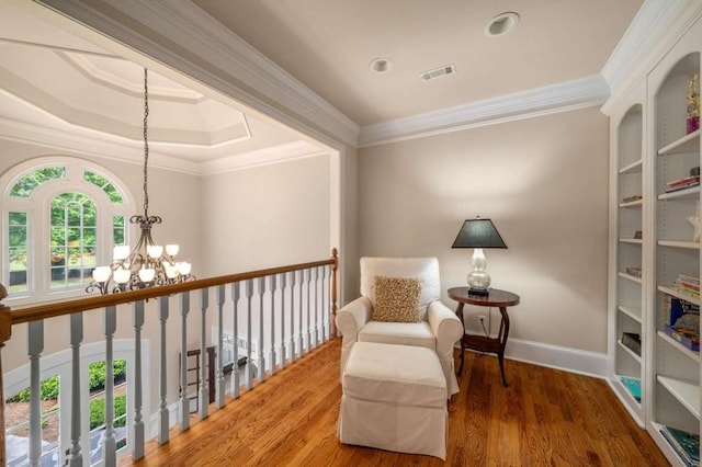 living area with a chandelier, ornamental molding, wood finished floors, baseboards, and recessed lighting