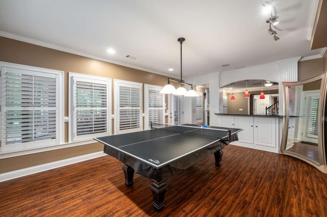 rec room featuring dark wood finished floors, recessed lighting, ornamental molding, and baseboards