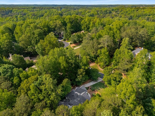 aerial view of property's location featuring a forest