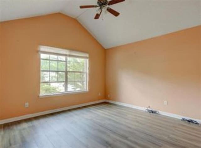 6684 Crane Ave, Fairburn, GA 30213 - empty room featuring wood finished floors, a ceiling fan, lofted ceiling, and baseboards