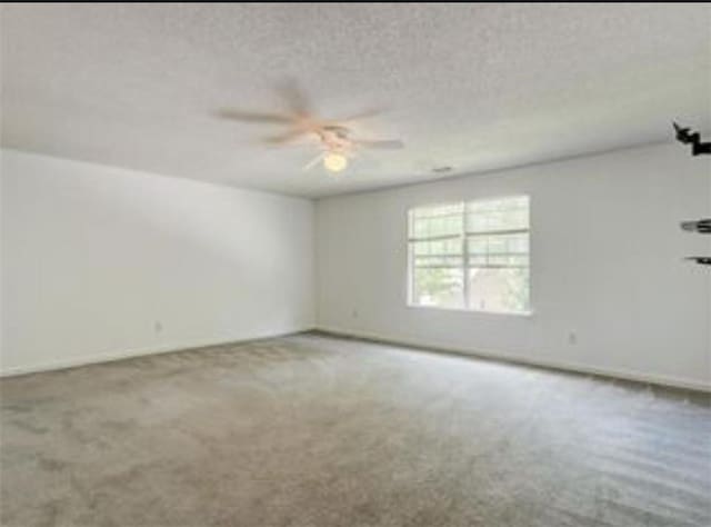 6684 Crane Ave, Fairburn, GA 30213 - spare room with carpet, ceiling fan, a textured ceiling, and baseboards