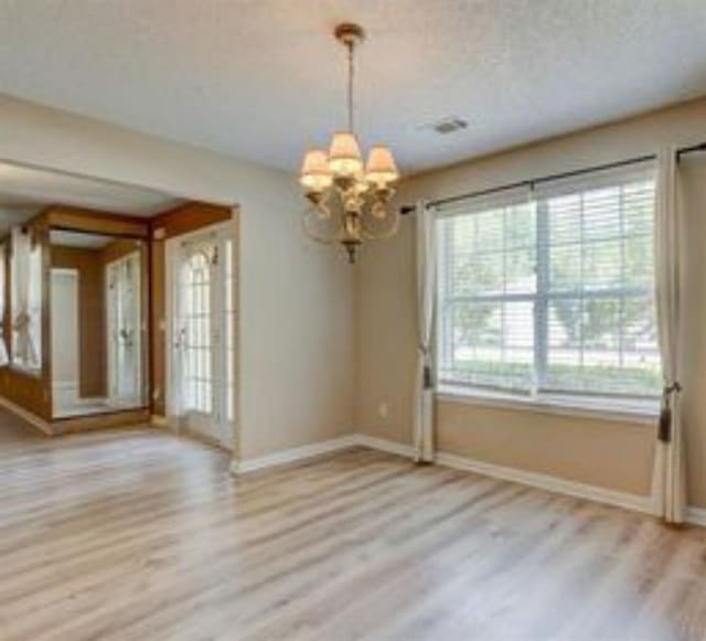 6684 Crane Ave, Fairburn, GA 30213 - unfurnished dining area featuring a chandelier, baseboards, and wood finished floors
