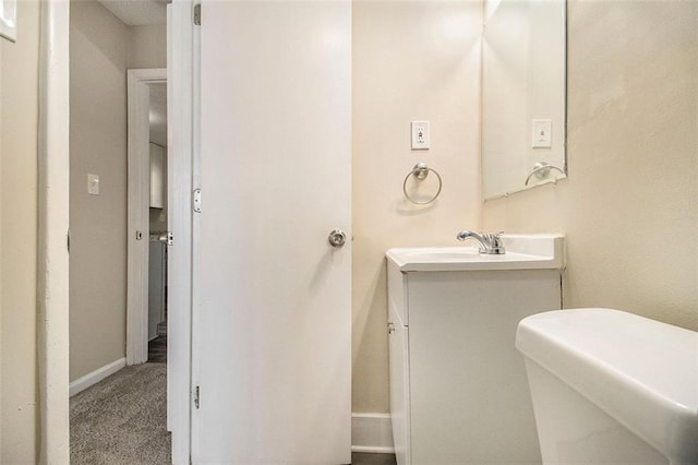 bathroom featuring toilet and vanity