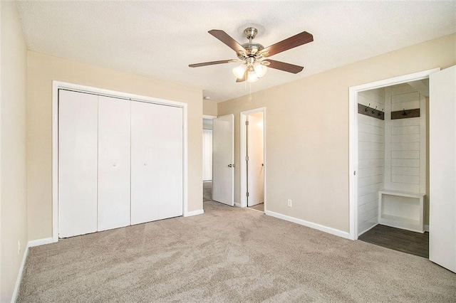 unfurnished bedroom with ceiling fan, light colored carpet, connected bathroom, and a closet