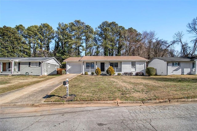 ranch-style home with a front yard and a garage