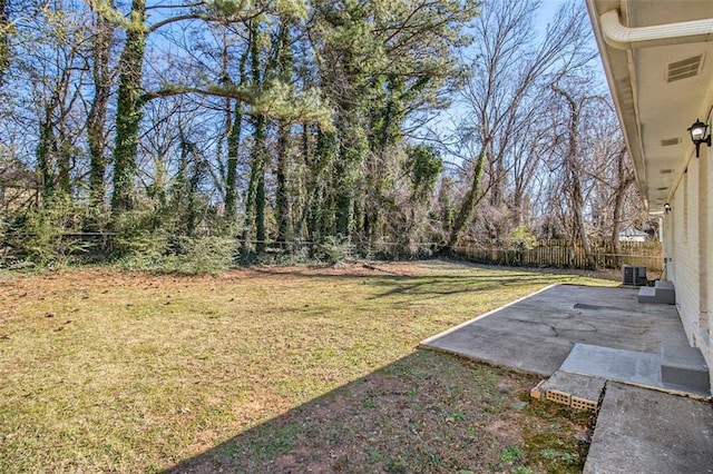 view of yard with central air condition unit and a patio