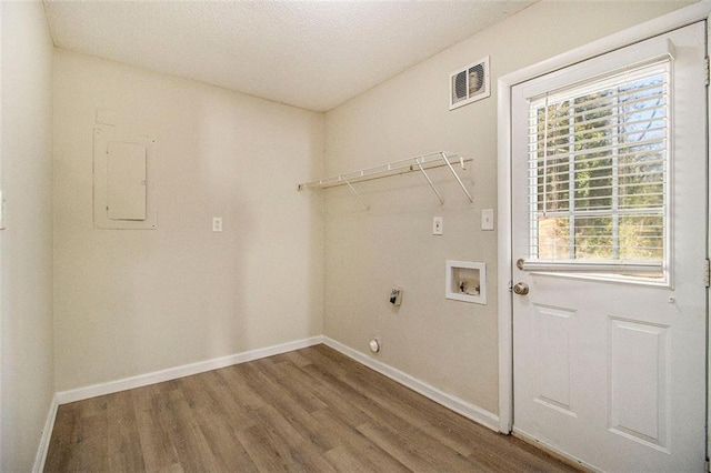 laundry area featuring electric panel, wood-type flooring, hookup for a washing machine, and electric dryer hookup