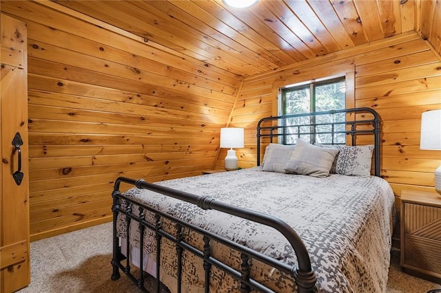 carpeted bedroom featuring wooden ceiling and wood walls