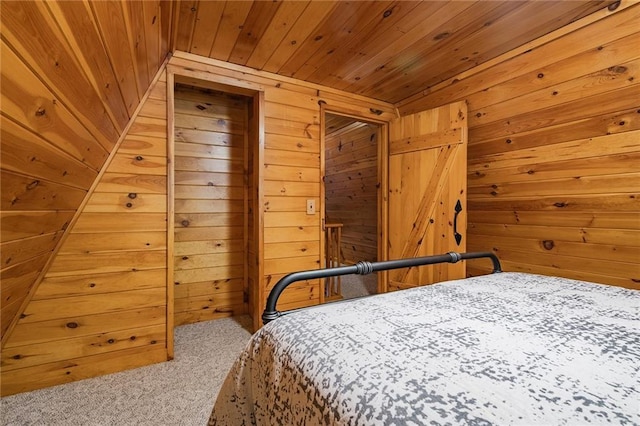 bedroom featuring carpet floors, wooden walls, and wooden ceiling