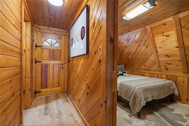 bedroom with wooden ceiling and wooden walls