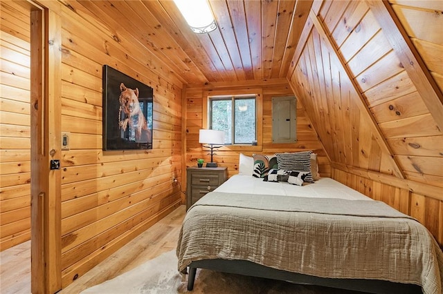 bedroom featuring electric panel, wood walls, wooden ceiling, and light wood finished floors