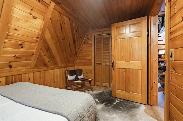 bedroom with wooden walls and wooden ceiling