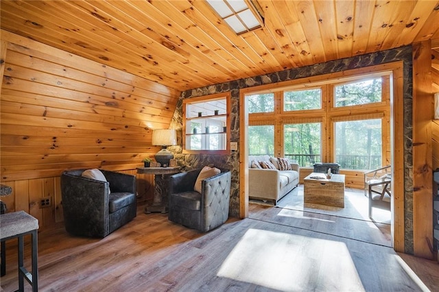 living room with wood finished floors, wood ceiling, wood walls, and vaulted ceiling