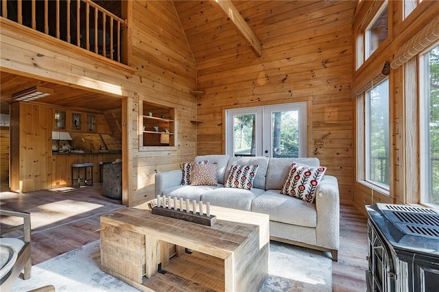 living room featuring wood finished floors, french doors, and wood walls