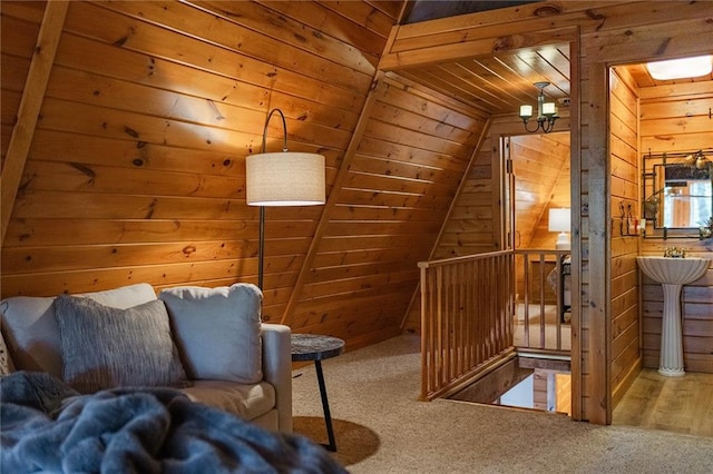 bonus room featuring wooden ceiling, wooden walls, a notable chandelier, and carpet floors