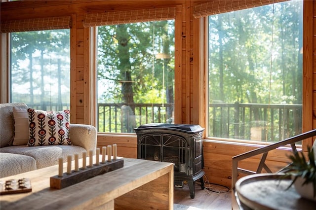 sunroom with a wealth of natural light and a wood stove