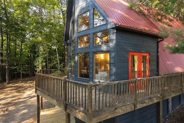 exterior space with a wooden deck and metal roof