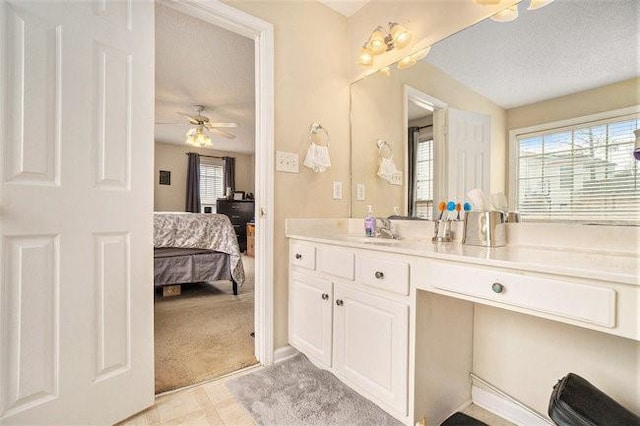 bathroom featuring vanity, tile patterned flooring, a textured ceiling, and ceiling fan