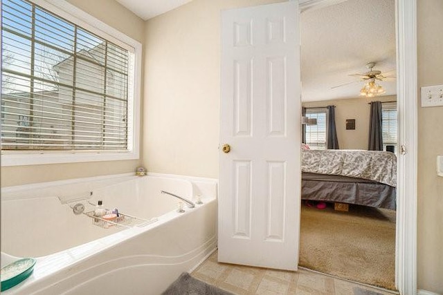 bathroom featuring a bath and ceiling fan