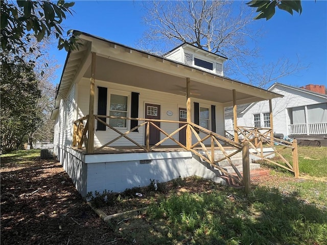 view of front of house with crawl space, covered porch, and central AC unit