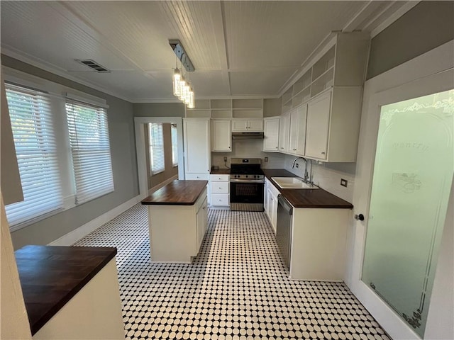 kitchen with a sink, visible vents, white cabinets, wooden counters, and appliances with stainless steel finishes