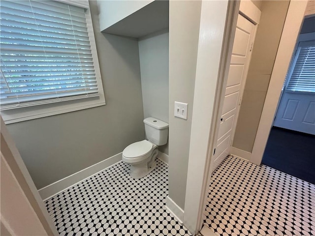 bathroom featuring toilet and baseboards