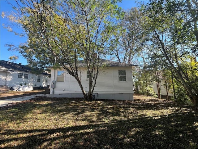 exterior space with entry steps, crawl space, and a lawn